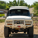 White off-road vehicle with large tires on a dirt road