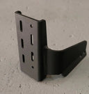Black metal bracket on a gray concrete surface